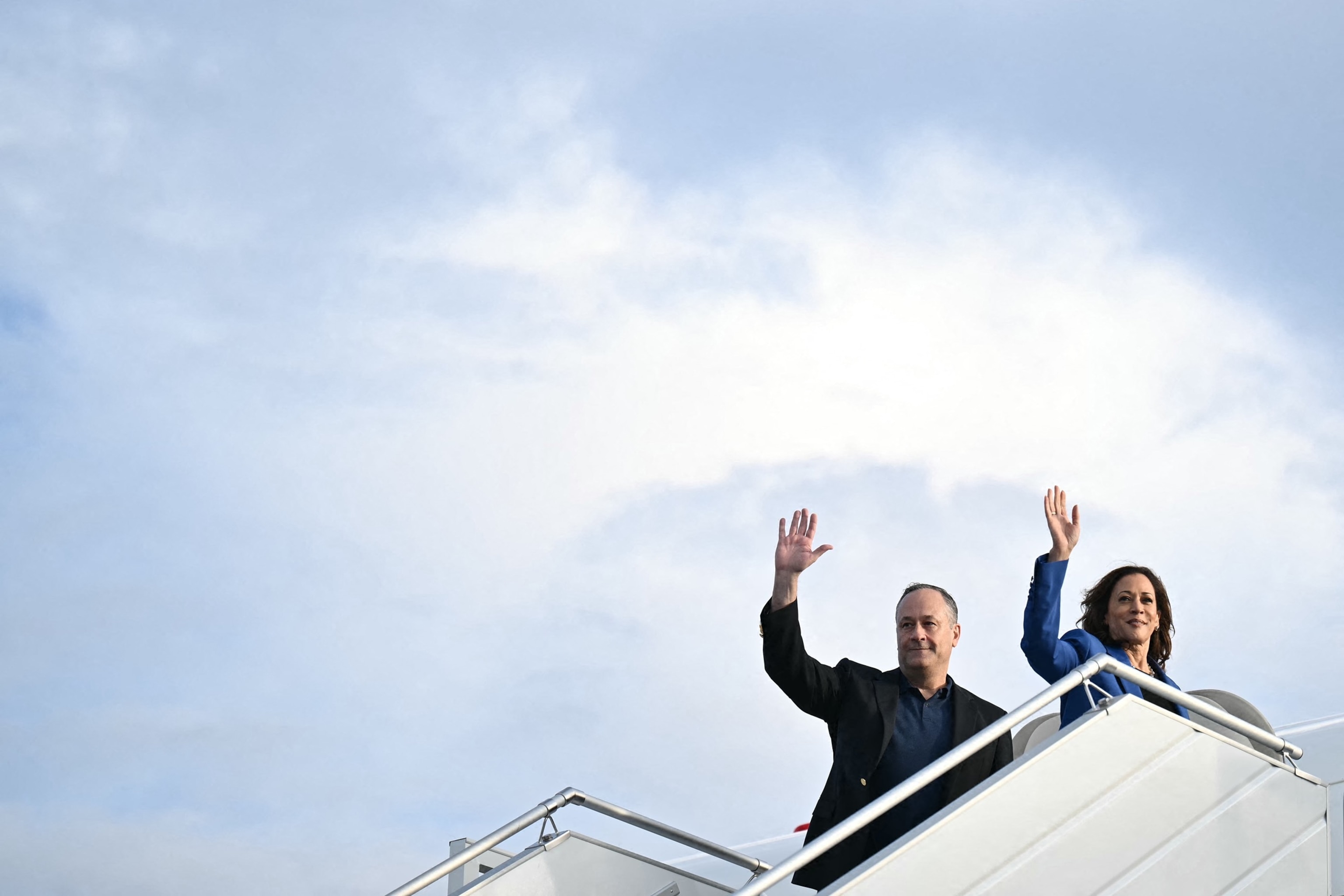 PHOTO: Vice President and Democratic presidential candidate Kamala Harris and husband, second gentleman Doug Emhoff, wave as they board Air Force Two in Pittsburgh, Pennsylvania, on Aug. 18, 2024, en route to Chicago, Illinois.